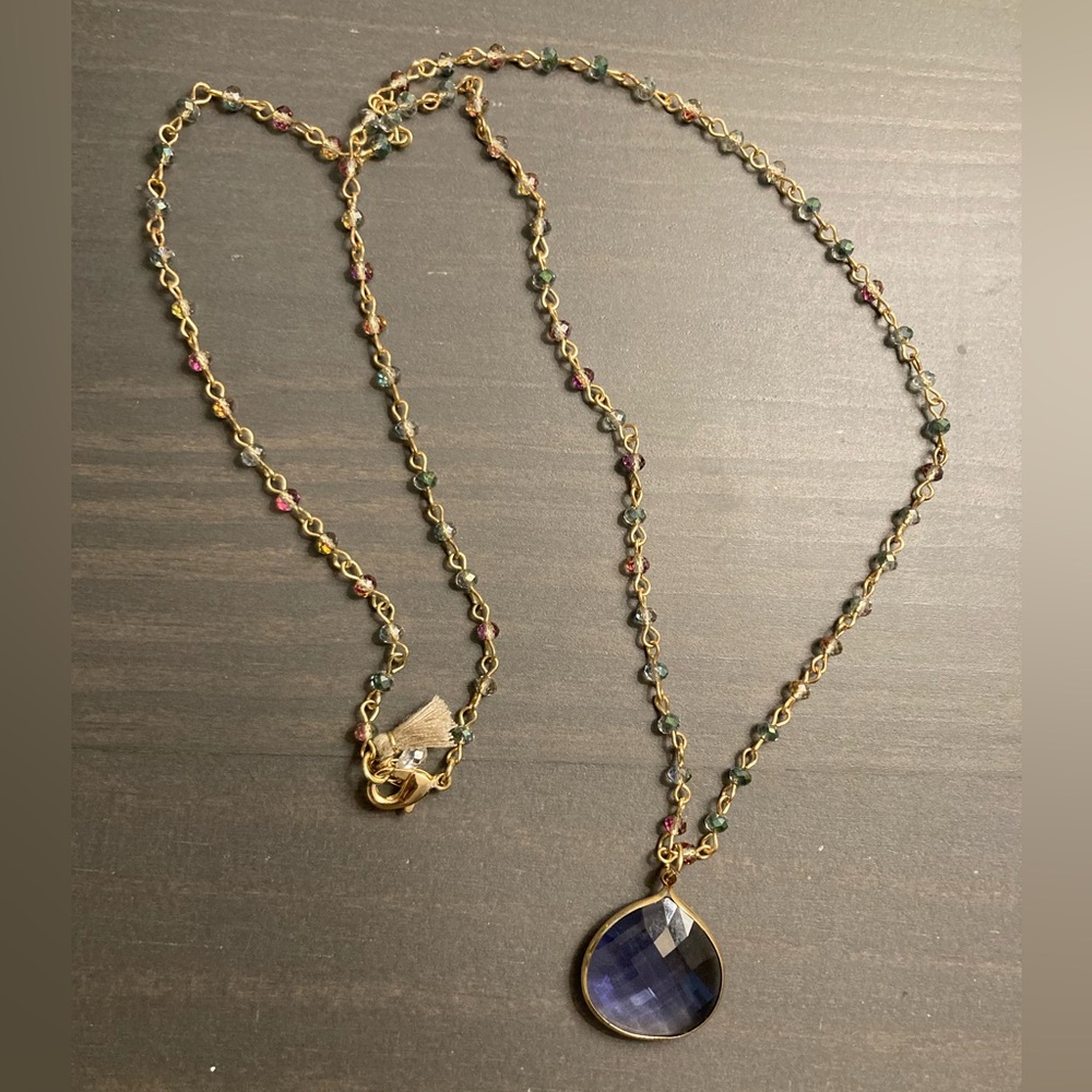 Gold toned and beaded necklace with blue tone jeweled pendant - 29 inches
